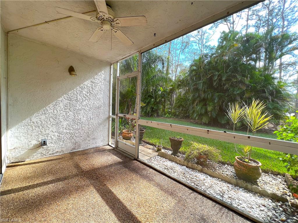 3471 County Barn Road, Unit F102 Naples, FL 34112 - Photo 17 of 19 a view of a balcony with a chair and potted plants