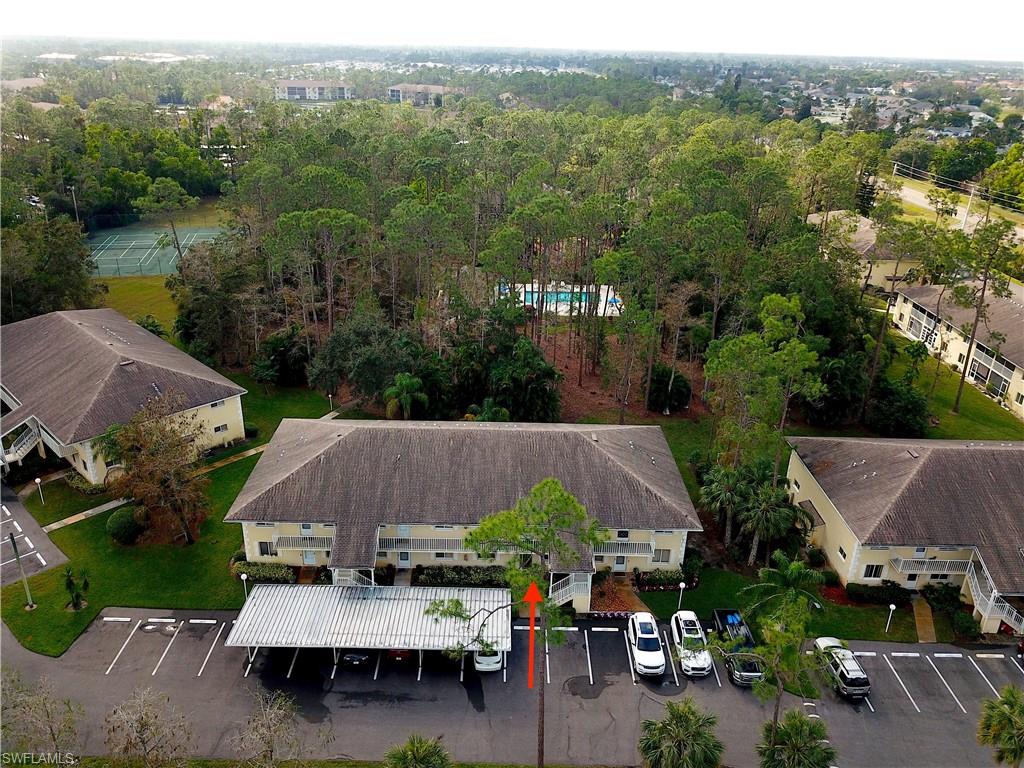 3471 County Barn Road, Unit F102 Naples, FL 34112 - Photo 2 of 19 an aerial view of a house with a garden and lake view