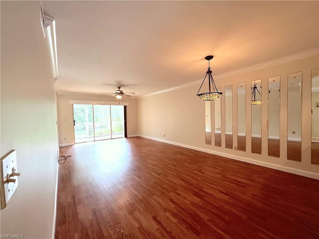 3471 County Barn Road, Unit F102 Naples, FL 34112 - Photo 7 of 19 a view of a room with wooden floor staircase and windows