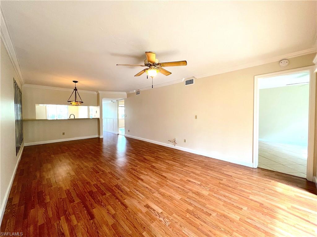 3471 County Barn Road, Unit F102 Naples, FL 34112 - Photo 8 of 19 wooden floor in an empty room