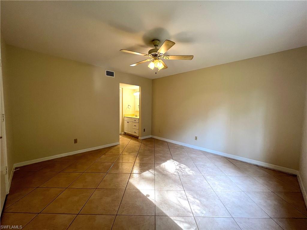 3471 County Barn Road, Unit F102 Naples, FL 34112 - Photo 9 of 19 a view of an empty room with a window