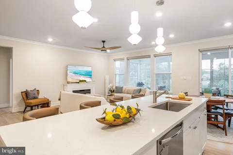 a living room with furniture kitchen and a chandelier