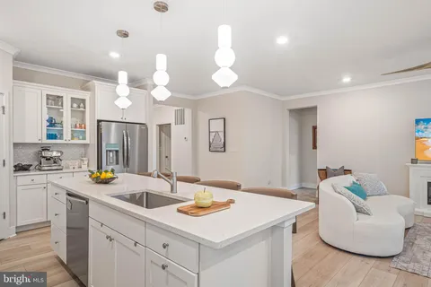 a kitchen that has a sink and a stove in it