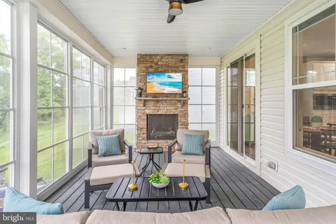 a living room with furniture a fireplace and a large window
