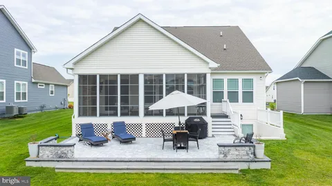 a front view of a house with a yard table and chairs