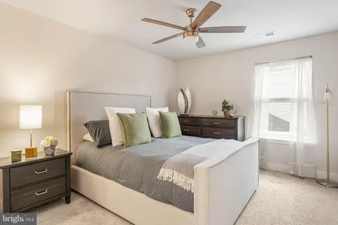 a bedroom with a large bed and a window