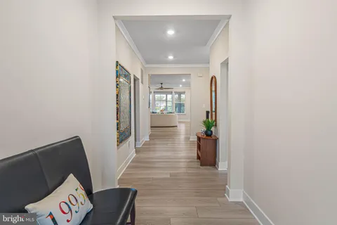a view of a hallway to a livingroom with furniture