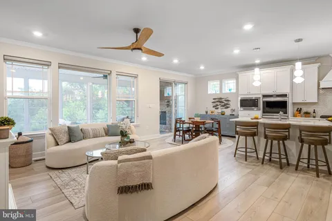 a living room with fireplace furniture and a large window