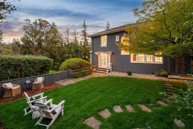 a backyard of a house with table and chairs