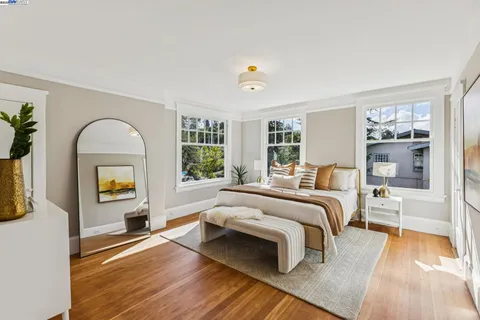 a bedroom with a bed and a mirror