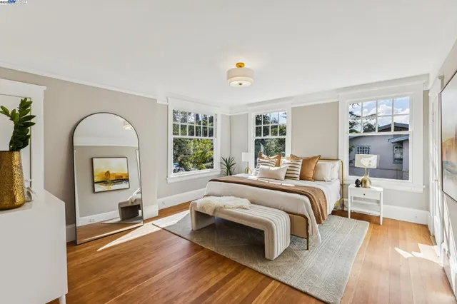 a bedroom with a bed and a mirror