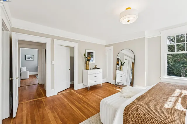 a bedroom with two beds and a large window