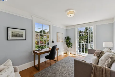 a view of a yoga room with wooden floor and a window