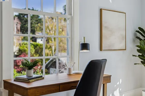 a view of a livingroom with furniture wooden floor and windows