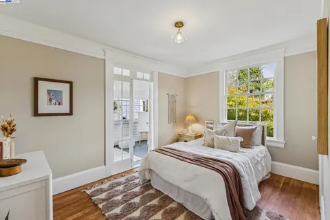 a bed sitting in a room next to a window