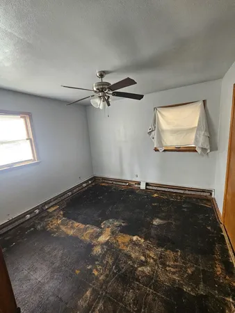 a view of a room with window and a ceiling fan