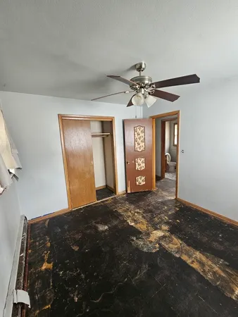 a view of an empty room with window and cabinet