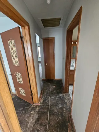 a view of storage and utility room with water heater and racks