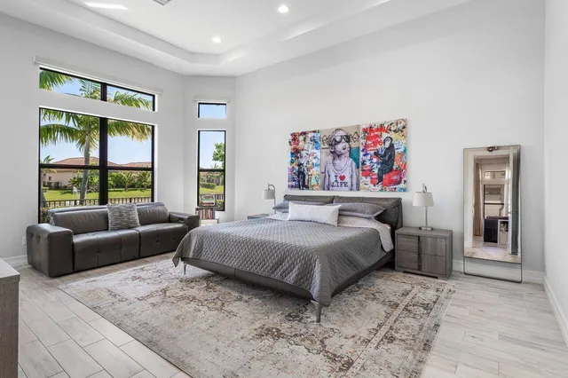 a bedroom with a large bed and a window