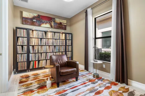 a living room with large windows and a table