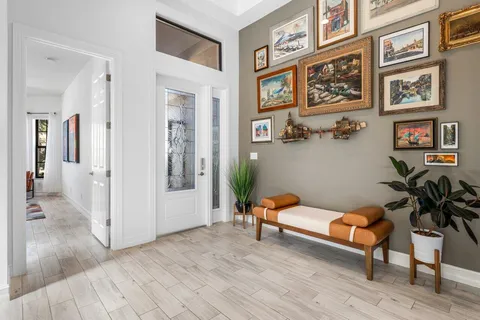 a living room with furniture and paintings on the wall