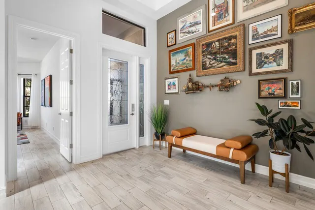 a living room with furniture and paintings on the wall