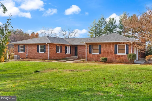 a kitchen with stainless steel appliances granite countertop wooden cabinets and white stove top oven