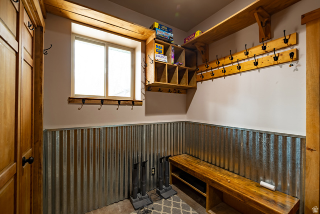2029 West Tollgate Road Coalville, UT 84017 - Photo 12 of 36 Wood-paneled door, corrugated metal wainscoting, wood bench with lower storage, wood shelving, and multiple coat hooks