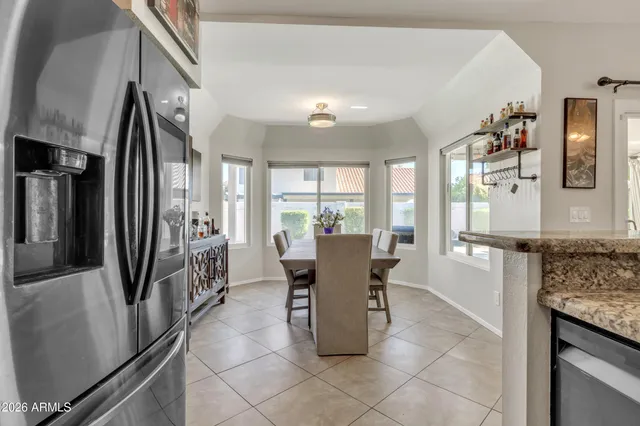 a dining room with furniture a chandelier and wooden floor