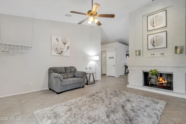 a living room with furniture a dining table and a refrigerator