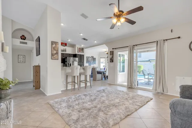 a living room with furniture potted plant and windows