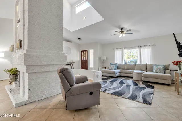 a living room with fireplace furniture and a flat screen tv