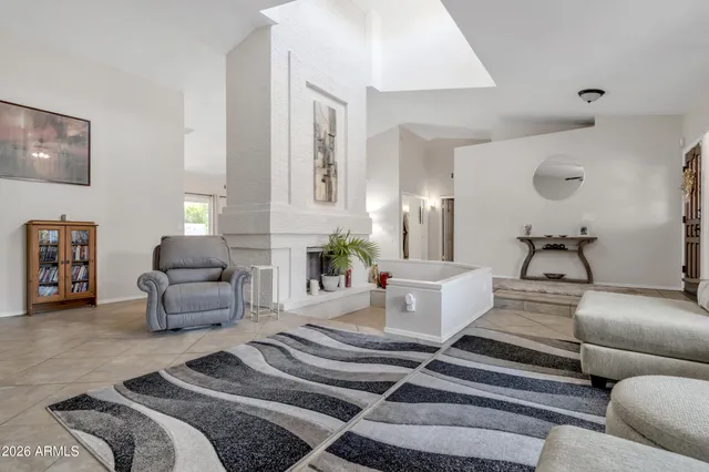 a living room with furniture and flowers