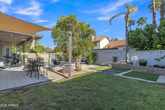 an aerial view of a house with a yard lake view and mountain view