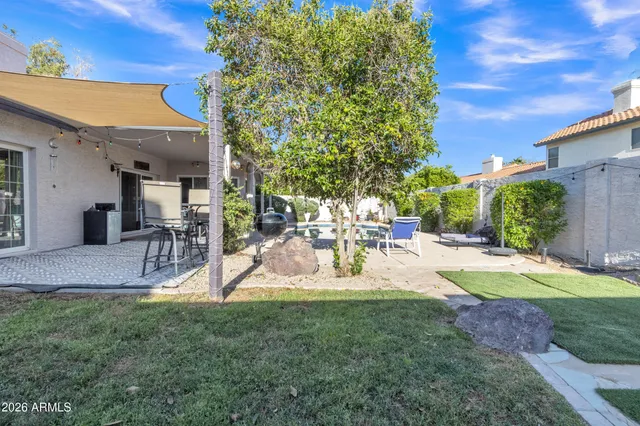 an aerial view of a city with lots of residential buildings ocean and mountain view in back