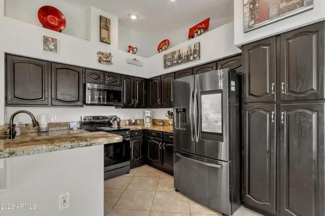 a view of a kitchen with a sink and stainless steel appliances