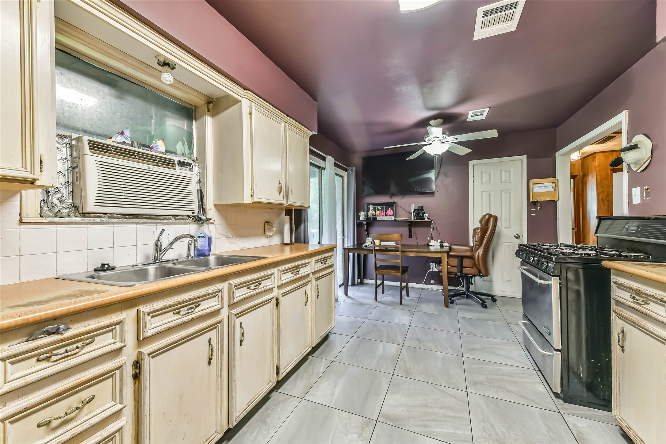 10438 Caxton Street Houston, TX 77016 - Photo 21 of 24 a kitchen with granite countertop a sink cabinets and stainless steel appliances