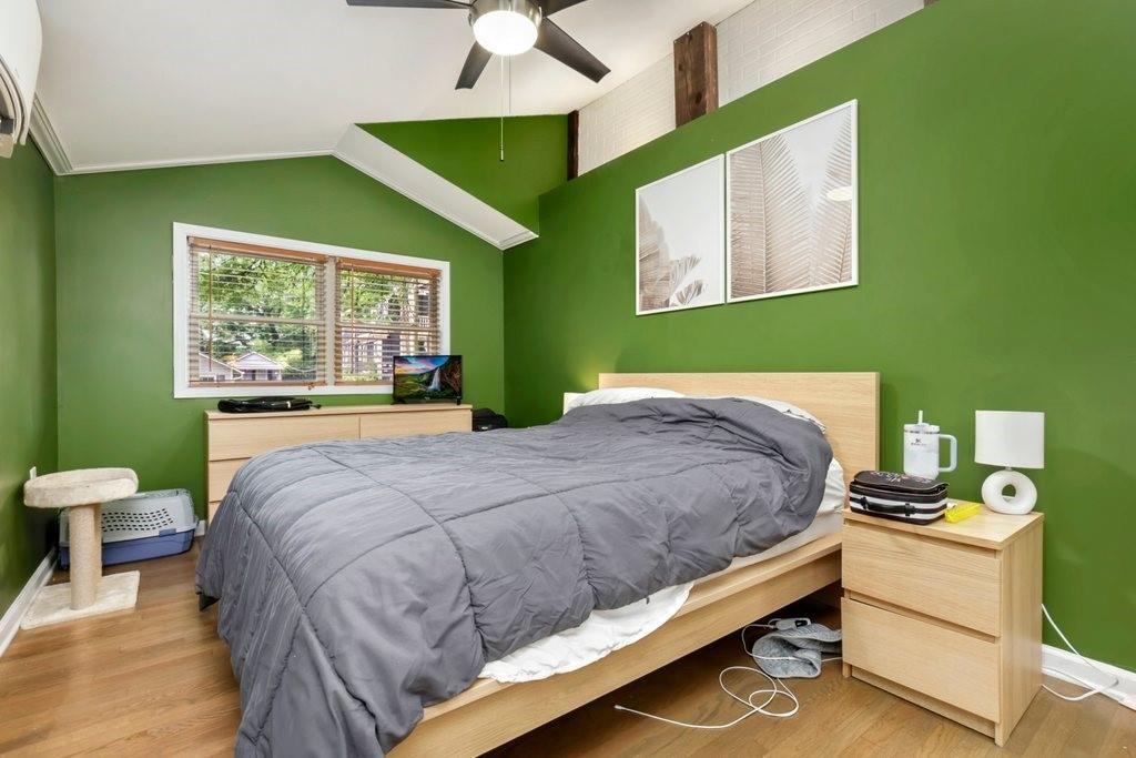 677 Holmes Street Northwest Atlanta, GA 30318 - Photo 11 of 31 a bed sitting in a bedroom next to a window