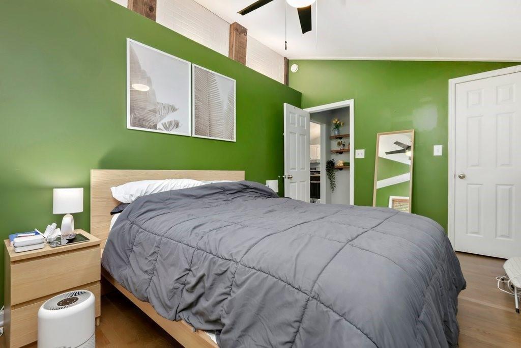 677 Holmes Street Northwest Atlanta, GA 30318 - Photo 12 of 31 a bedroom with a bed and a large mirror