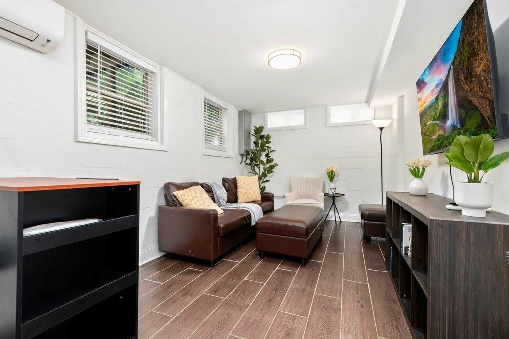 677 Holmes Street Northwest Atlanta, GA 30318 - Photo 15 of 31 a living room with furniture and a painting on the wall