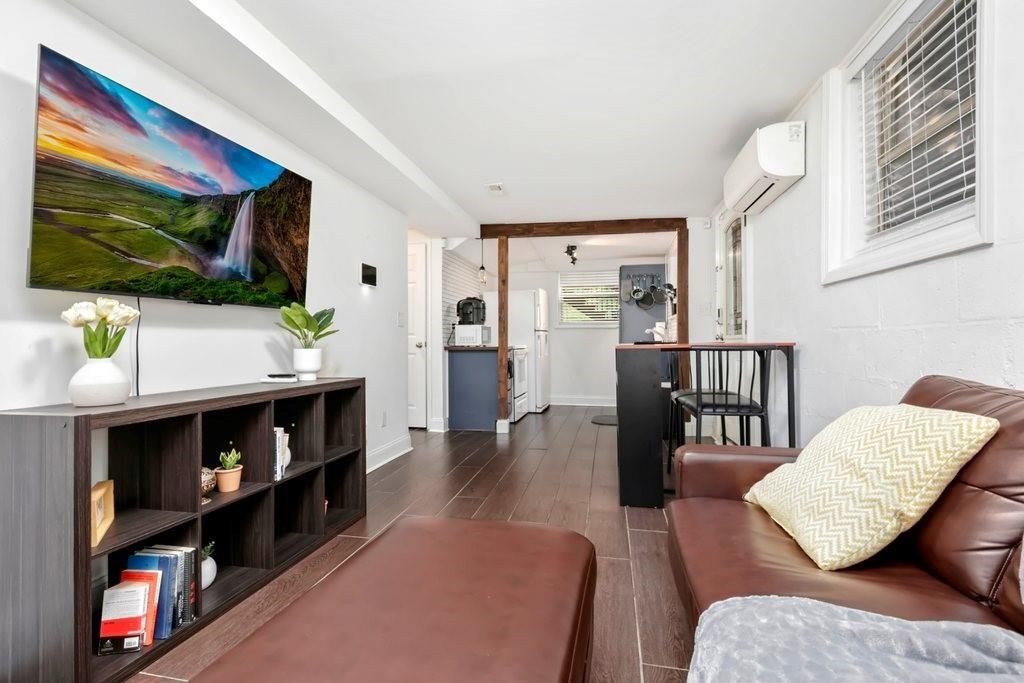 677 Holmes Street Northwest Atlanta, GA 30318 - Photo 16 of 31 a living room with furniture and a flat screen tv