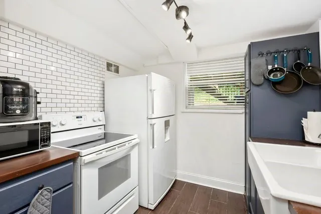 a kitchen with stainless steel appliances a refrigerator and a stove