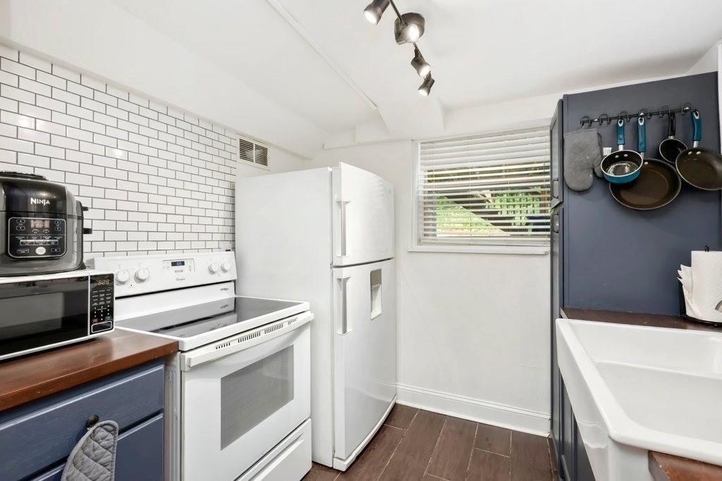 677 Holmes Street Northwest Atlanta, GA 30318 - Photo 19 of 31 a kitchen with stainless steel appliances a refrigerator and a stove