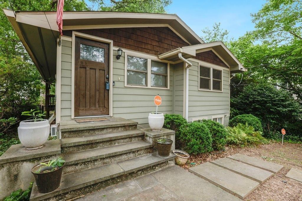 677 Holmes Street Northwest Atlanta, GA 30318 - Photo 2 of 31 a front view of a house with a garden