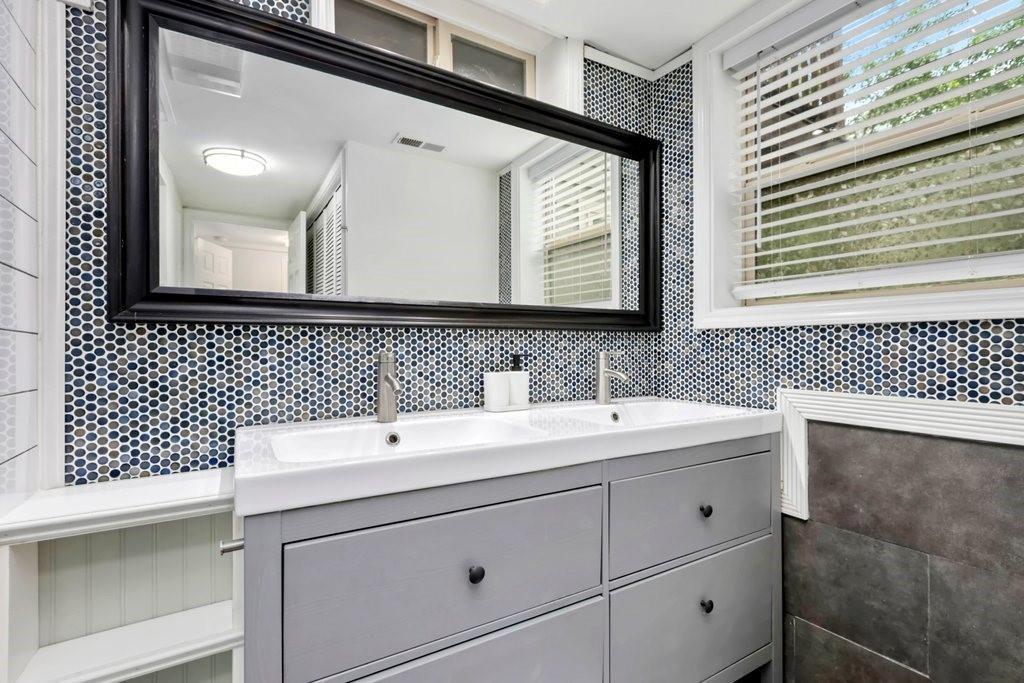 677 Holmes Street Northwest Atlanta, GA 30318 - Photo 23 of 31 a bathroom with a sink and a mirror