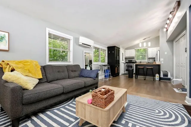a living room with furniture and wooden floor