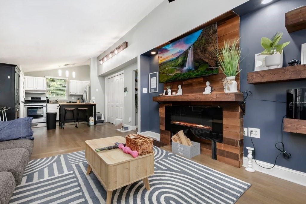677 Holmes Street Northwest Atlanta, GA 30318 - Photo 6 of 31 a living room with furniture and a fireplace