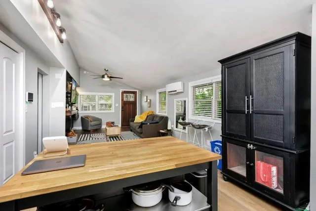 a room with kitchen island granite countertop furniture and a fireplace