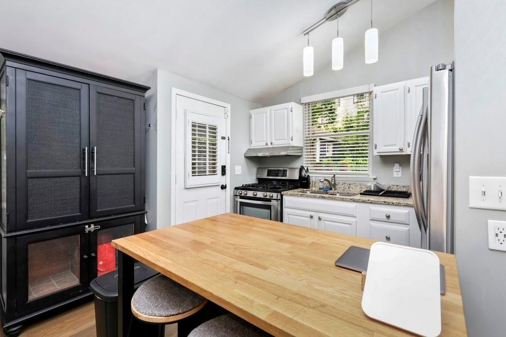 677 Holmes Street Northwest Atlanta, GA 30318 - Photo 10 of 31 a kitchen with a refrigerator and a stove top oven