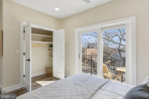a bedroom with a large bed and a window